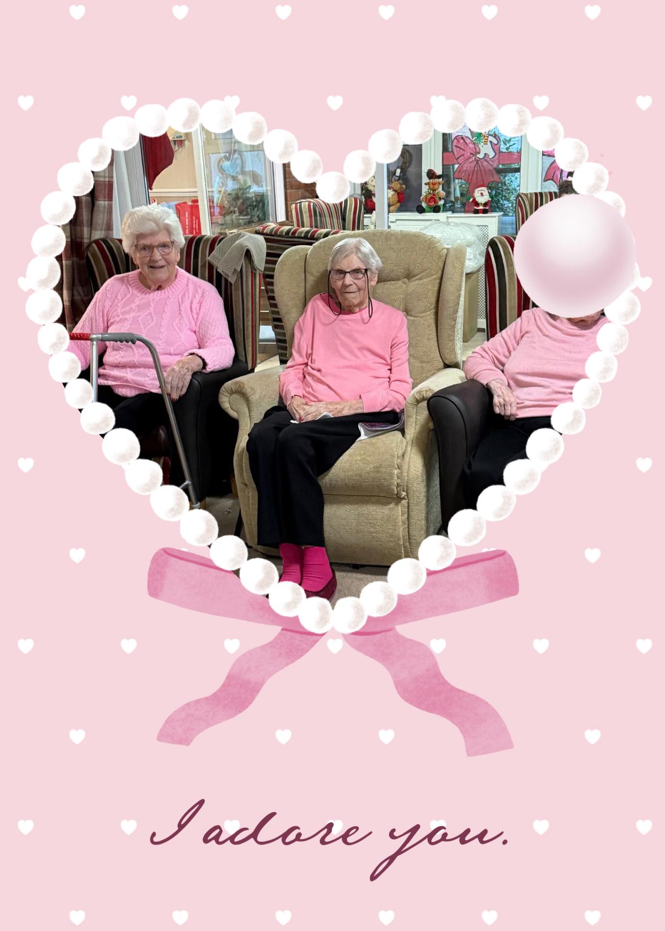 Three elderly women in pink outfits sitting together in a heart frame