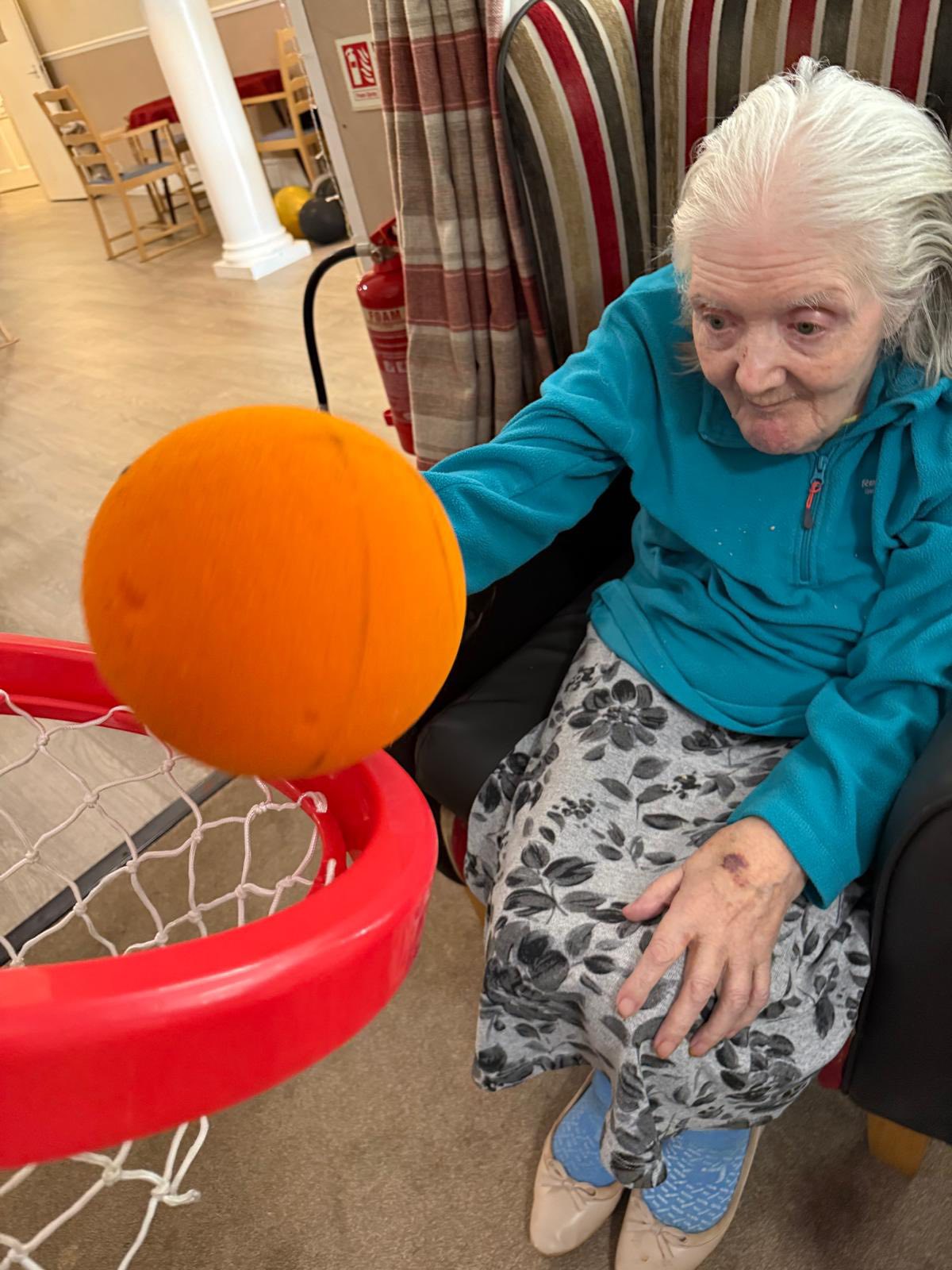 Resident enjoying indoor basketball