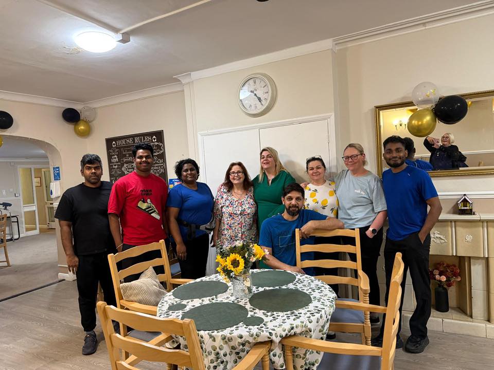 Staff standing together and smiling