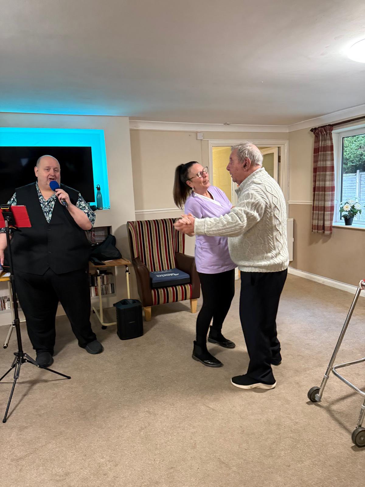 Senior residents dancing together during a music activity session