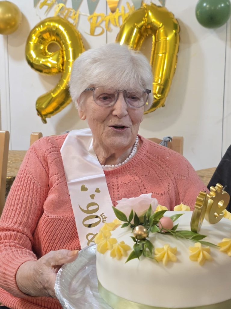 Birthday moment with cake and “90” decorations