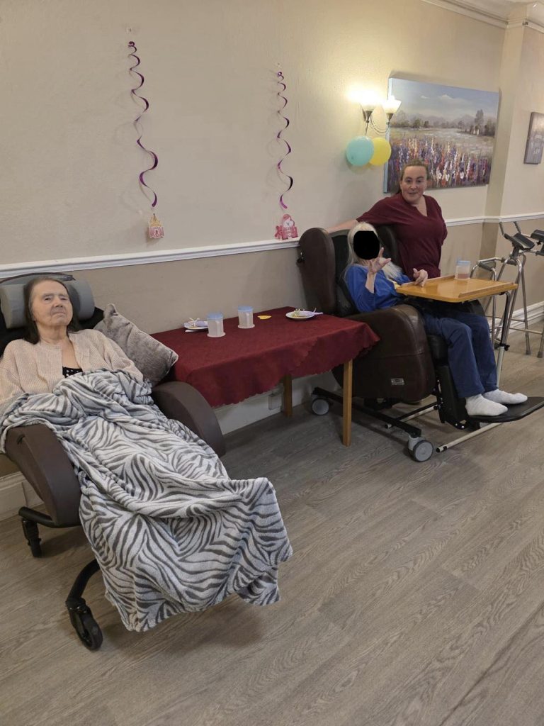 Care staff interacting with residents in a lounge area