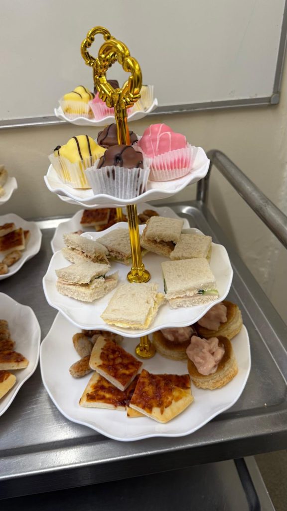 Sandwiches, pastries, and sweets arranged for serving