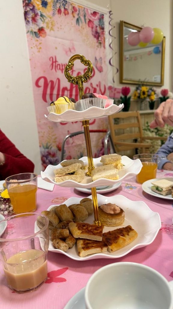 Sandwiches and pastries served on a three-tier tray