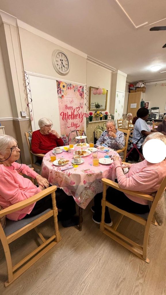 Elderly women having tea at a Mother’s Day table.