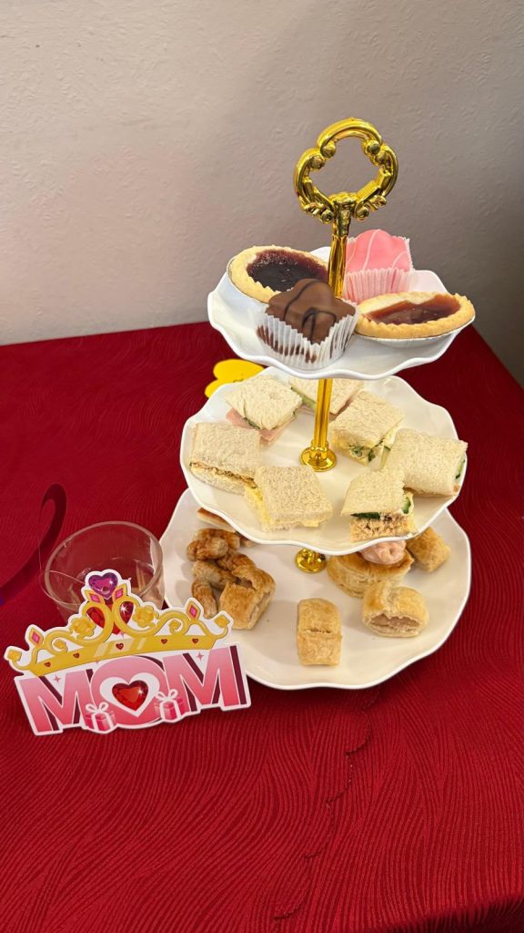 Mini sandwiches and sweets on a stand