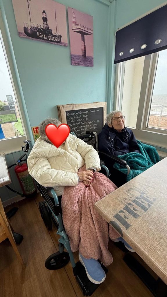 Residents enjoying time together in a café overlooking the seafront.