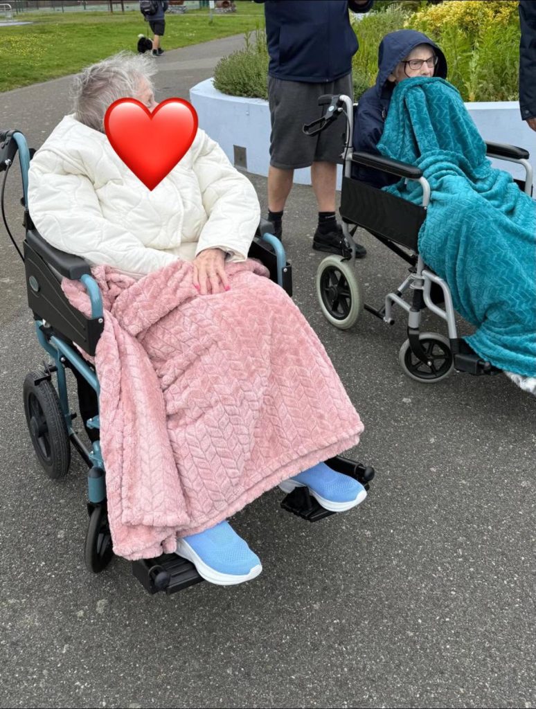 Residents enjoying a garden visit together during a day out.