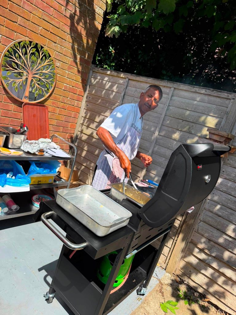 Chef preparing a barbecue for residents and visitors.