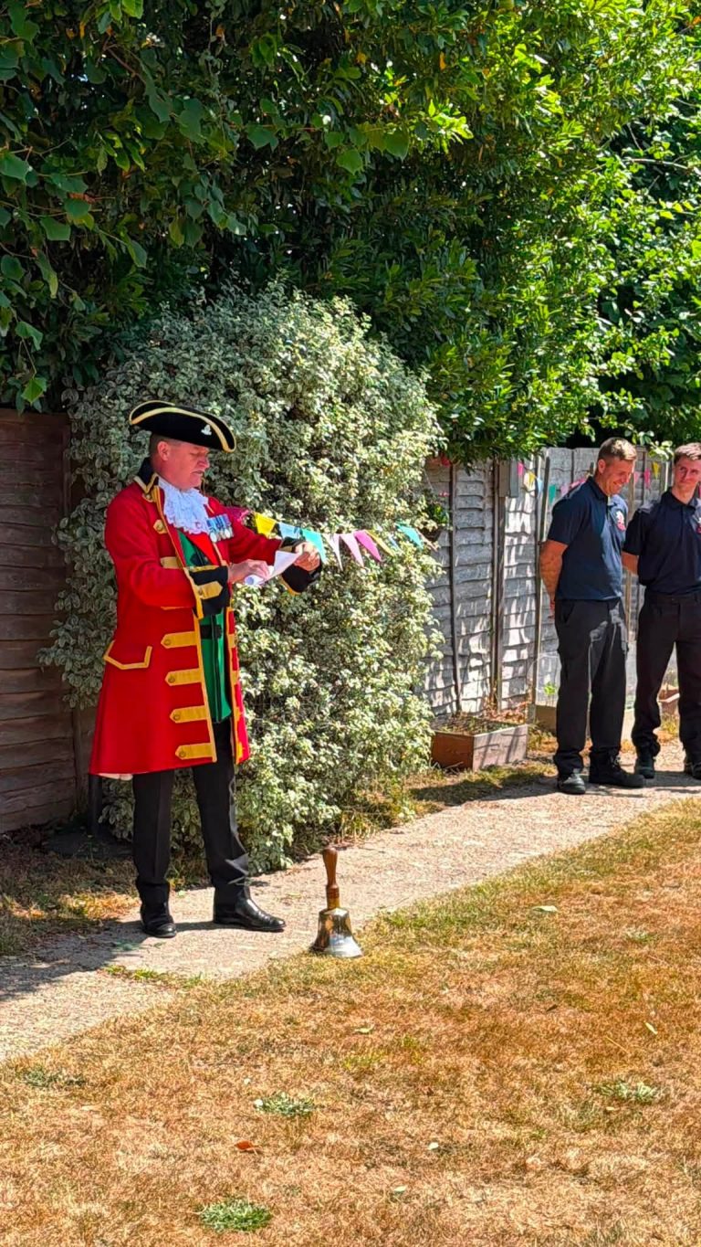 Town crier speaking during a community celebration at Orchard House Nursing Home.