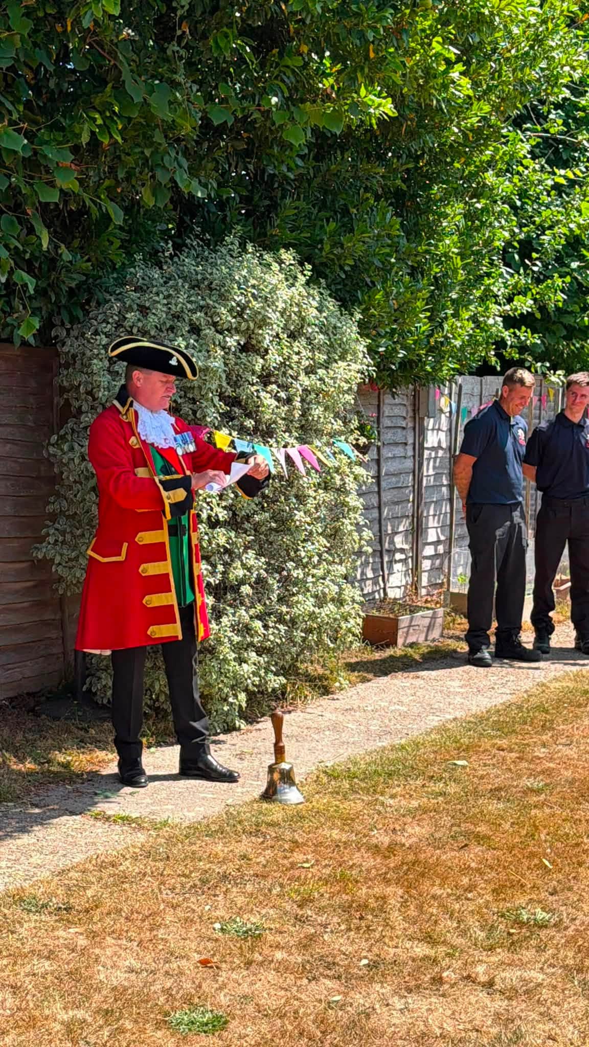 Town crier speaking during a community celebration at Orchard House Nursing Home.