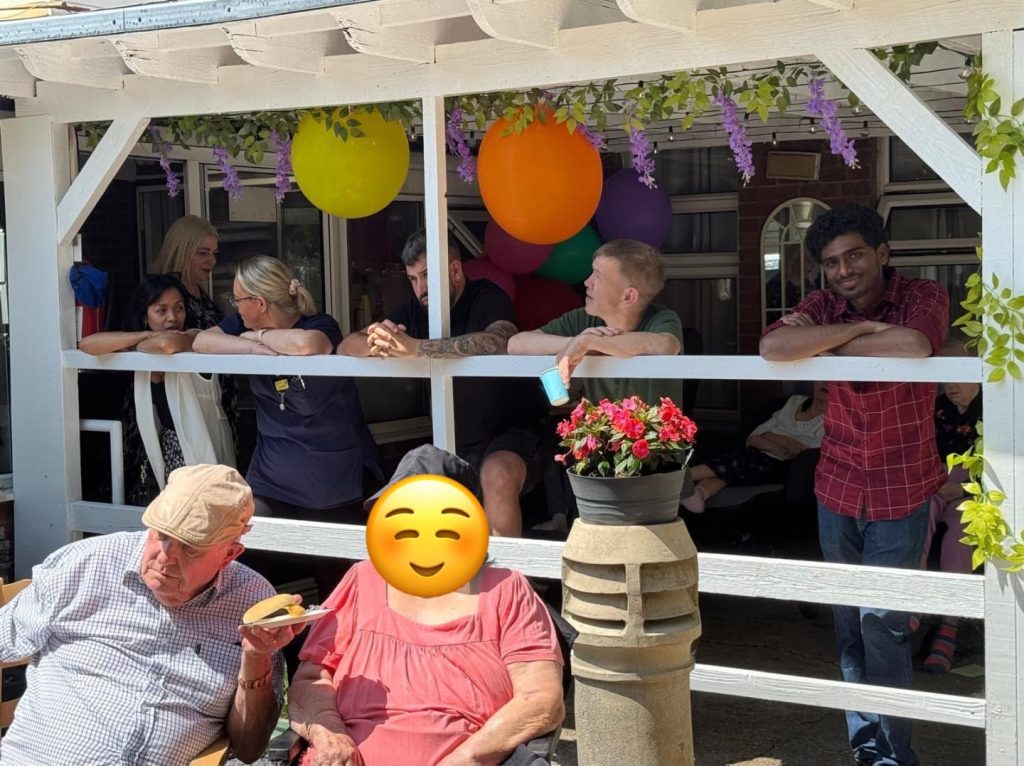 Residents and visitors enjoying a summer garden gathering.