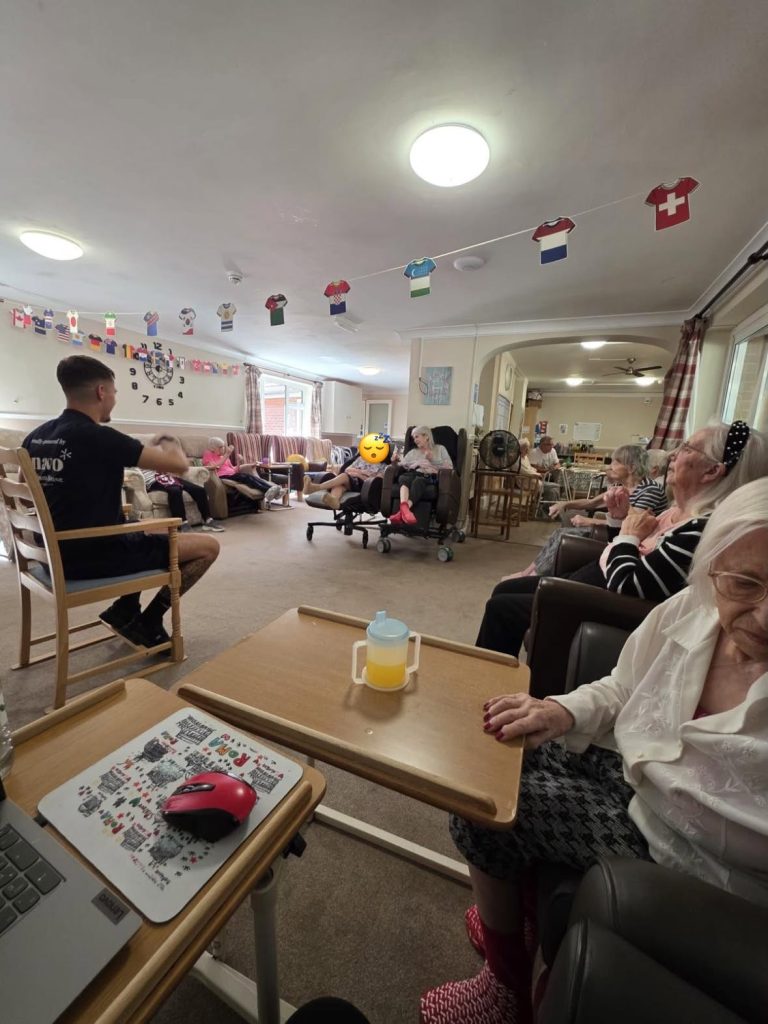 Older adults sit together during a group recreation session.